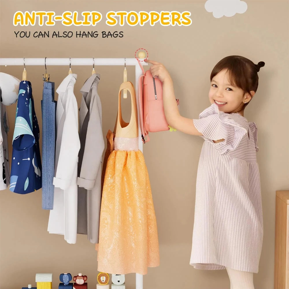 A & M BOUTIQUE white kids clothing rack with anti-slip stoppers, featuring a young girl hanging a pink bag on it.